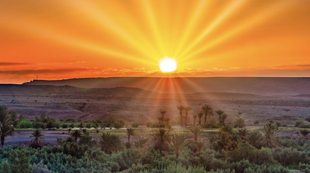 Sun rising over an arid landscape